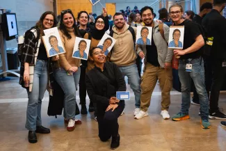Group of MacKenzie and Crouch lab members surrounding Kaylee, a Grad Slam finalist.